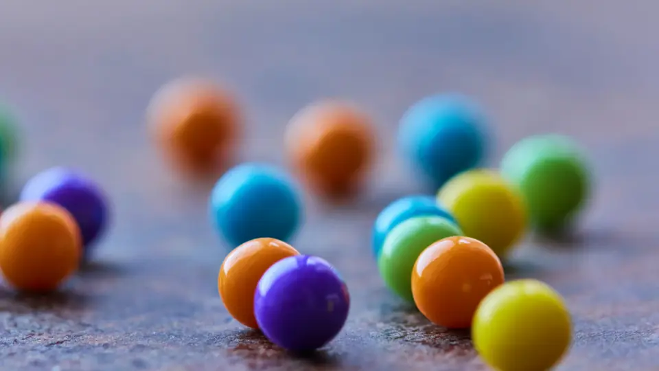 Snoepbolletjes in vrolijke kleuren op een grijze ondergrond
